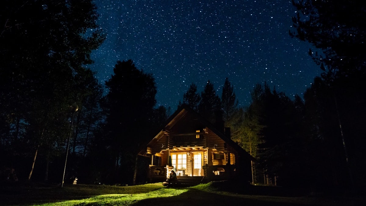 brown wooden house with lights turned on